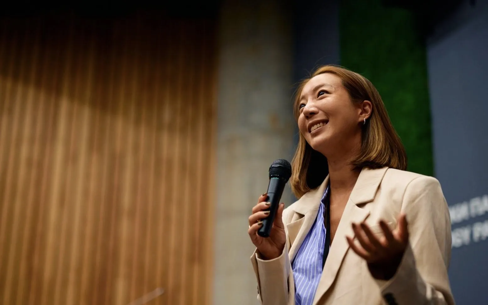 Speaker addressing an audience, microphone in hand